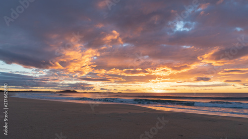 Fototapeta Naklejka Na Ścianę i Meble -  Colourful sunrise over the beach