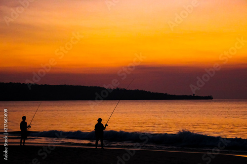 Fishermen on the beach on the island of Bali at sunset. © rdv27