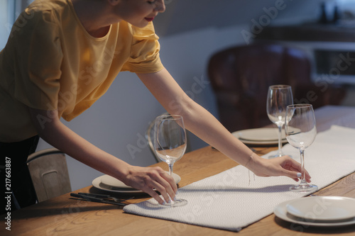 Fotografie Woman Setting up Dinner Table