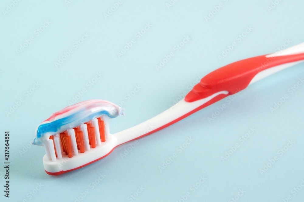 Colorful toothpaste on a toothbrush Colorful toothpaste on a toothbrush