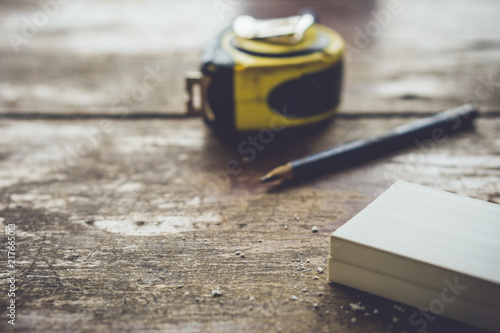 Fotografie Measuring tape, pencil and rack lying on wooden table