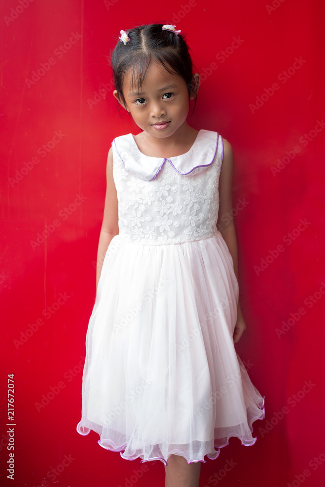 Cute asian little child girl on red background. Cute asian little child girl on red background.