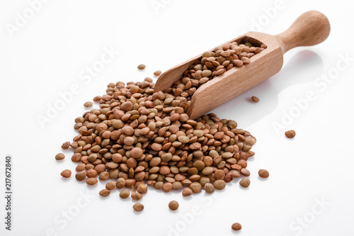 raw lentils on a white acrylic background photo