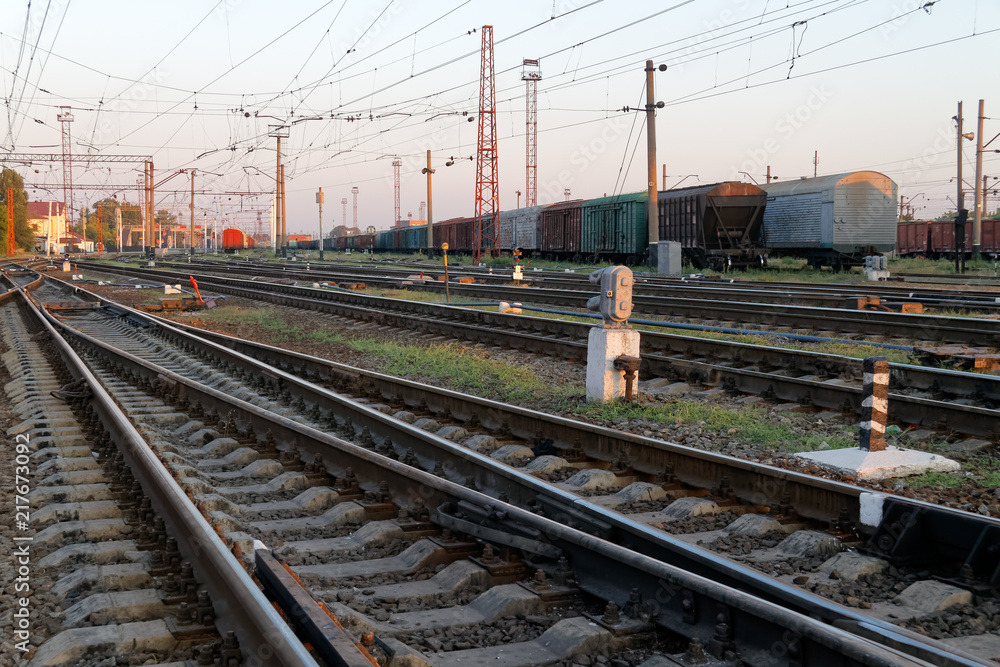 Railway pointwork, railway tracks on the station at summer sunset. Transportation