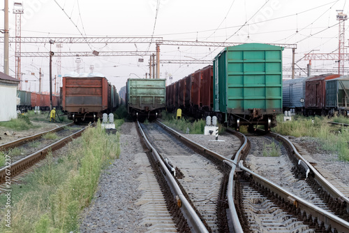 Сargo wagons parked at the railway freight station at a sunny summer evening