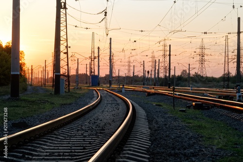 Railway pointwork, railway tracks on the station at summer sunset. Transportation