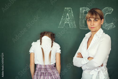 Bilde på lerret Female techer punishment her girl student over chalkboard