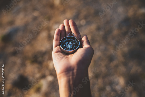 Hand holding compass looking for direction. Searching and exploring concept