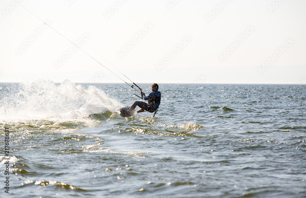 Kite surfing by the sea in sunny weather