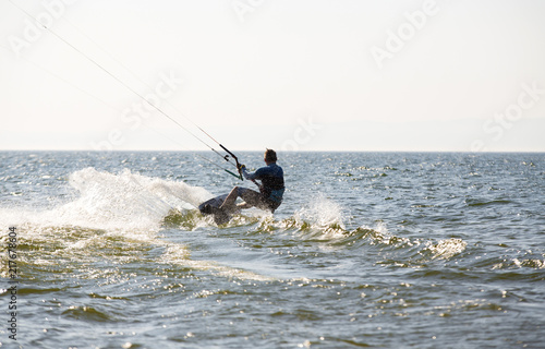 Kite surfing by the sea in sunny weather