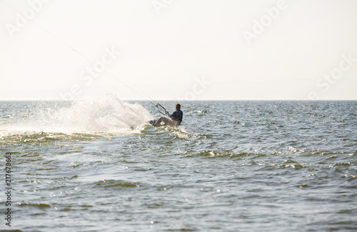 Kite surfing by the sea in sunny weather