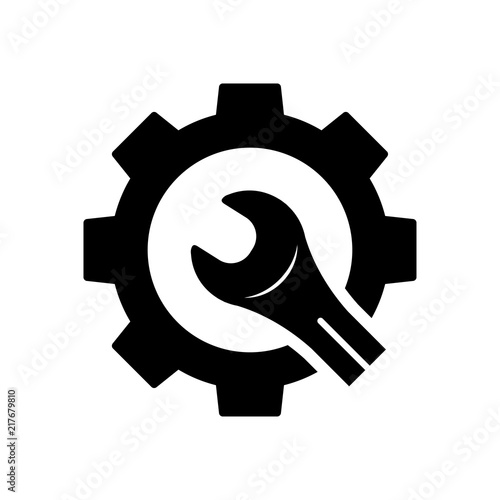 Icono plano engranaje con llave cortada en color negro