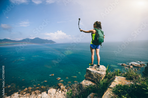 Obraz na płótnie Woman Hiking In Seaside Taking A Selfie