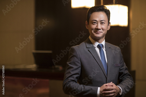 Portrait of confident hotel manager photo