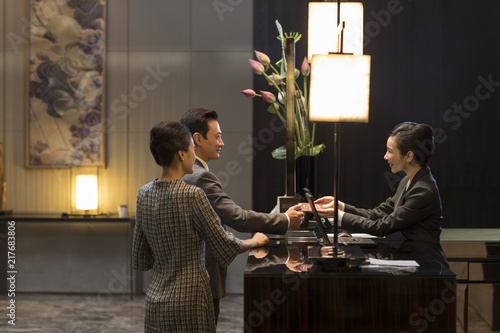 Couple checking into hotel