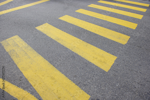 Yellow stripes of a city crosswalk