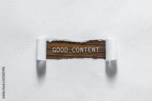 Good content is an inscription in torn white paper. The concept of creativity, an interesting channel.