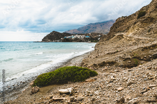 Crete, Greece. beach with rocks and cliffs with view towards sea ovean on a sunny day. photo