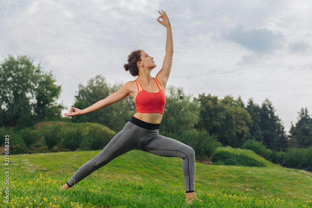 Good mood. Slim healthy dark-haired woman having good mood while doing yoga on nature Good mood. Slim healthy dark-haired woman having good mood while doing yoga on nature
