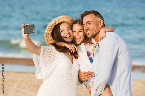 Canvas Print Happy family spending good time at the beach together
