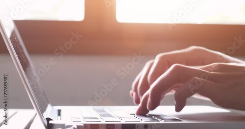hands typing on computer keyboard, moving camera, business man working on laptop pc in office photo