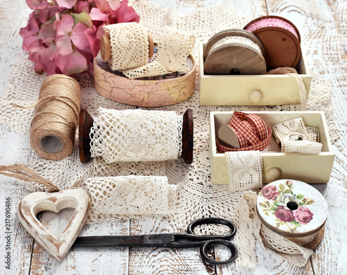 vintage style still life with lace trim spools and accessories
