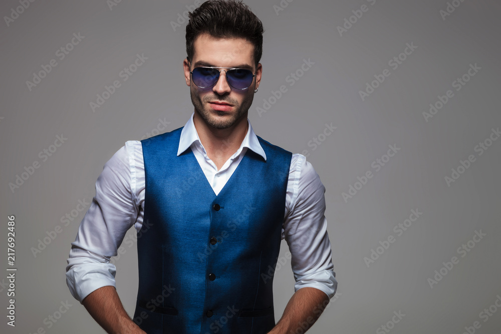 Fototapeta premium portrait of sexy young man with blue sunglasses
