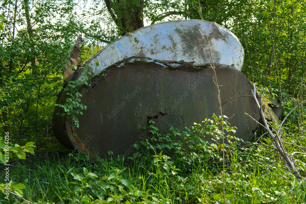 Old abandoned iron rusty tanks and metal structures. The crisis, the collapse of the economy, the cessation of production capacity, led to a collapse. The global catastrophe. Old abandoned iron rusty tanks and metal structures. The crisis, the collapse of the economy, the cessation of production capacity, led to a collapse. The global catastrophe.