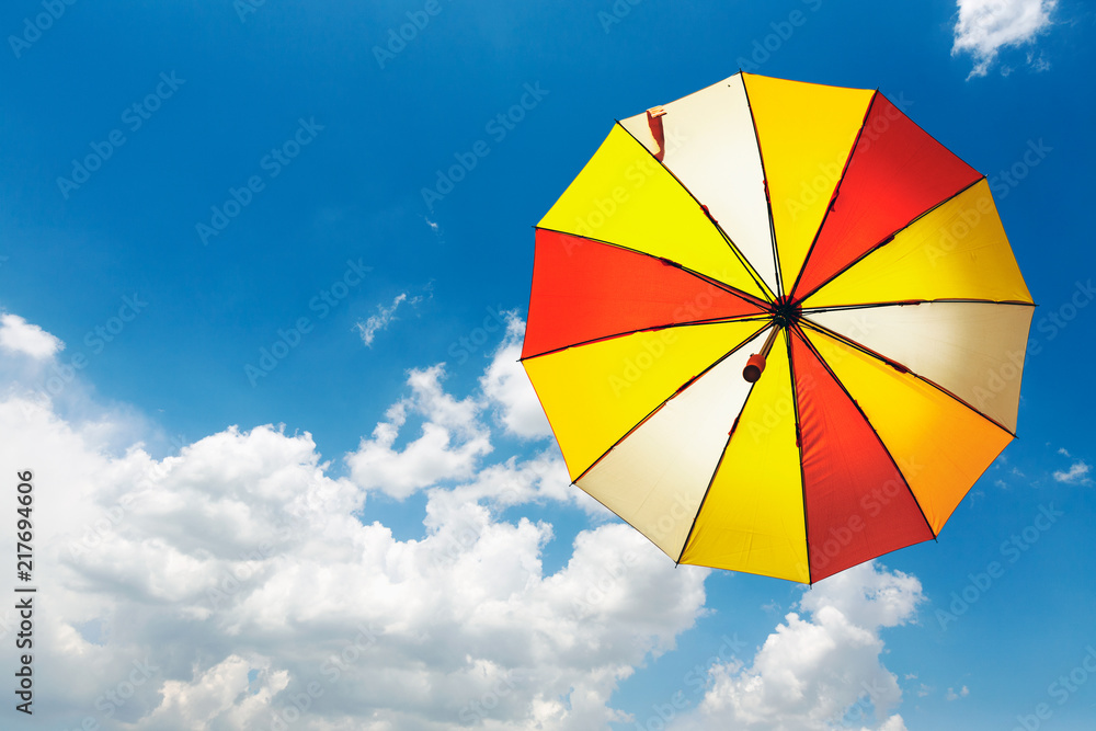Yellow umbrella on blue sky