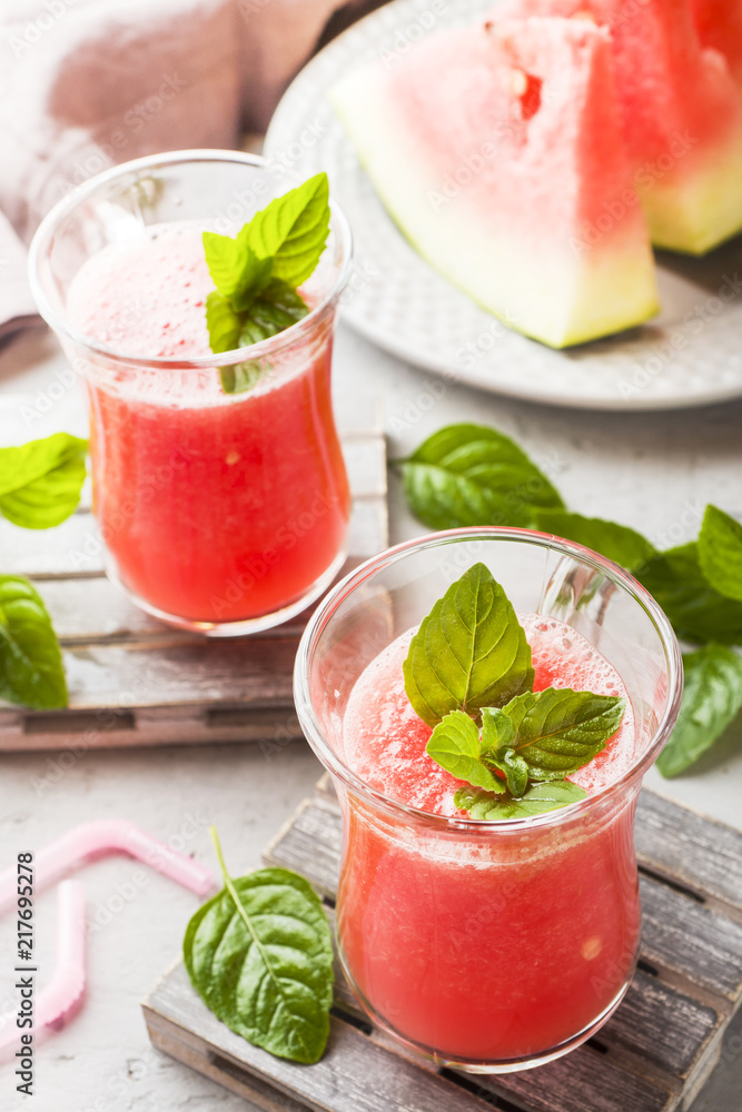 Fresh watermelon smoothie with ice and mint leaves in glasses. Fresh watermelon smoothie with ice and mint leaves in glasses.