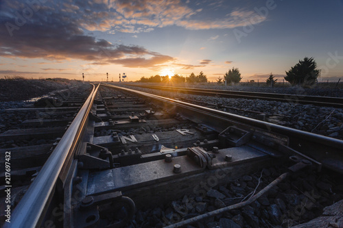 Obraz na płótnie Sunset Over Railway Tracks, Low Perspective with Detail View of Scene. w salonie
