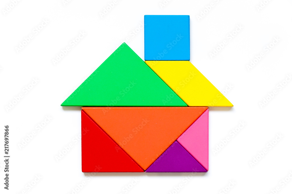Color wood tangram puzzle in home shape on white background Color wood tangram puzzle in home shape on white background