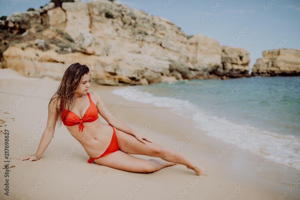 Young sexy Woman in red bikini lying on tropical beach Young sexy Woman in red bikini lying on tropical beach