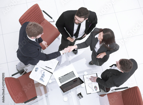 top view.handshake, businessman and business woman over a Desk