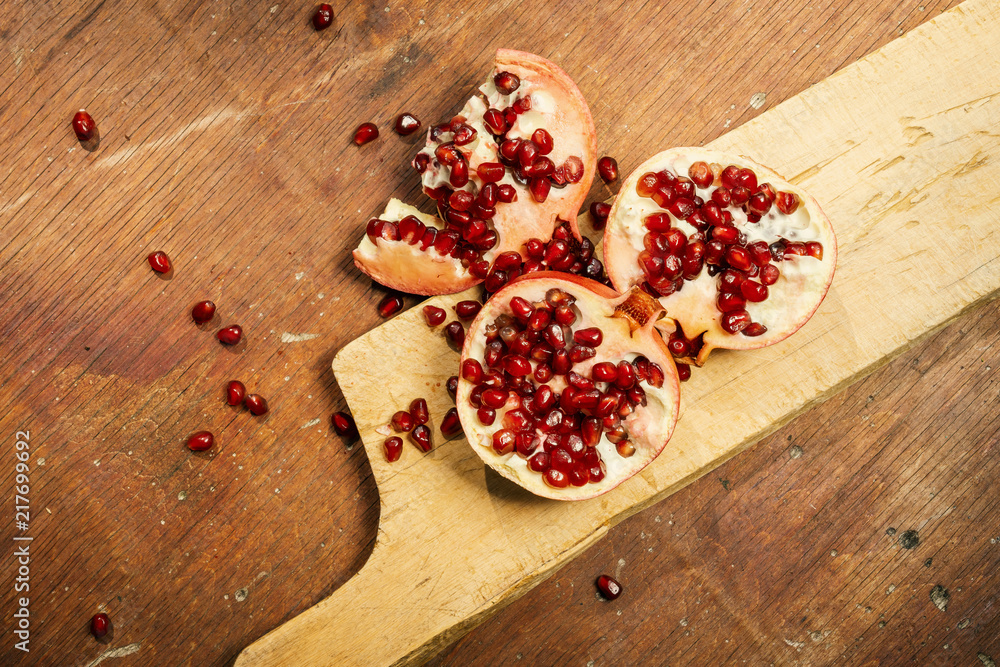 fresh pomegranate fruit on an old wooden table fresh pomegranate fruit on an old wooden table