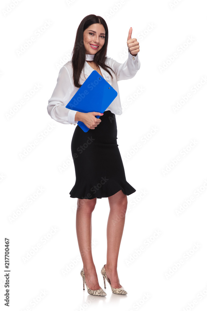 young businesswoman with blue clipboard makes ok sign young businesswoman with blue clipboard makes ok sign