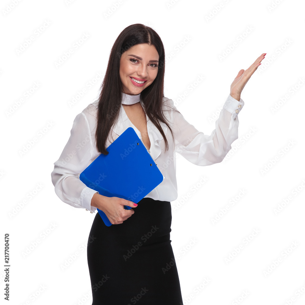portrait of smiling businesswoman presenting while holding clipboard portrait of smiling businesswoman presenting while holding clipboard