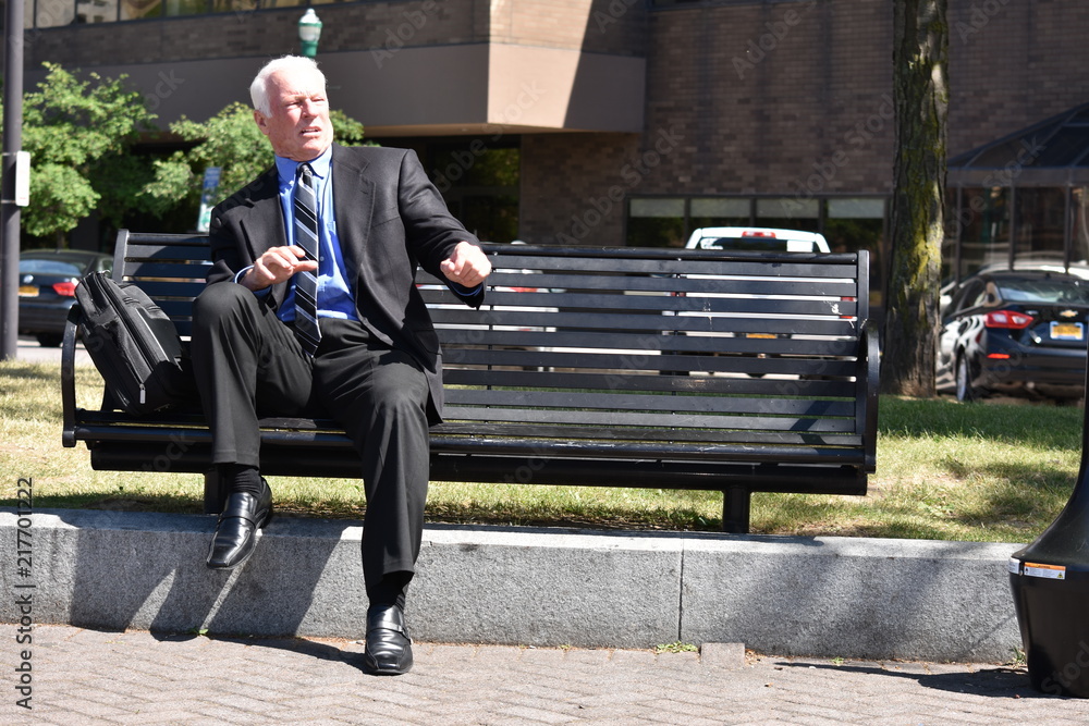 Εκτύπωση καμβά Shocked Adult Senior Business Man Sitting On Bench
