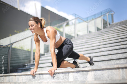 Sportive girl training out in the city