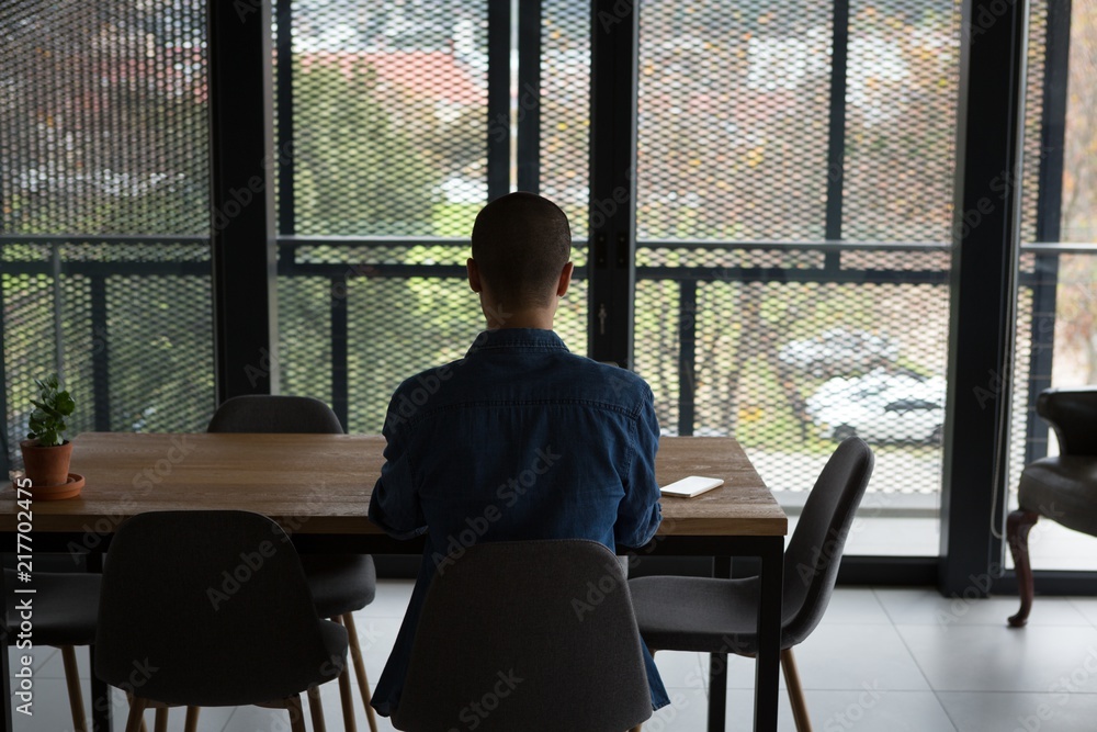 Man sitting on chair at home Man sitting on chair at home