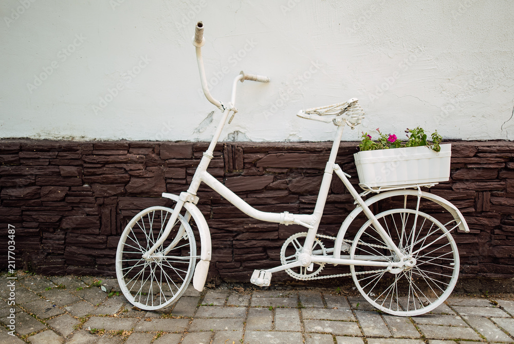 Urban bicycle with a fixed mechanism on the wall background, an old bicycle. Retro-stylish cycling in the city Urban bicycle with a fixed mechanism on the wall background, an old bicycle. Retro-stylish cycling in the city