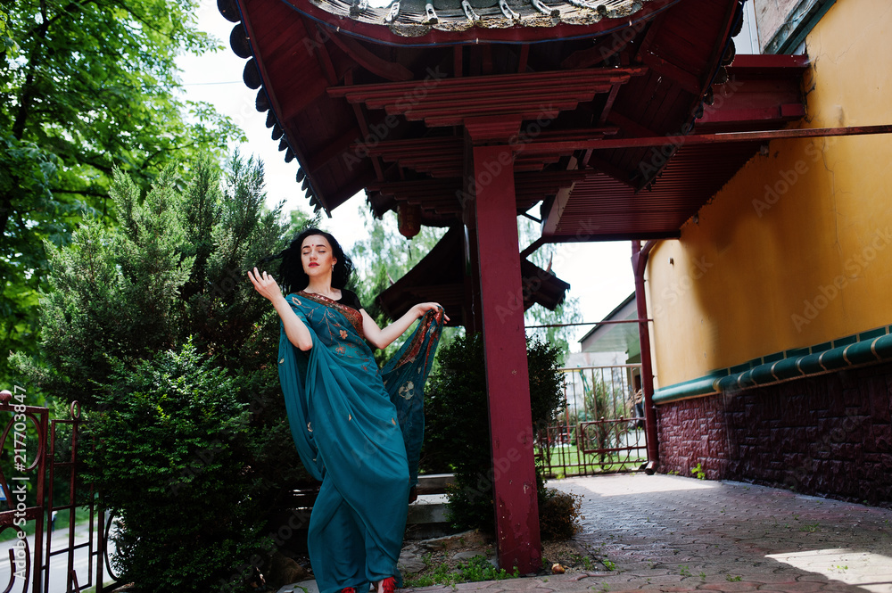 Portrait of beautiful indian brumette girl or hindu woman model against japanese traditional house.
