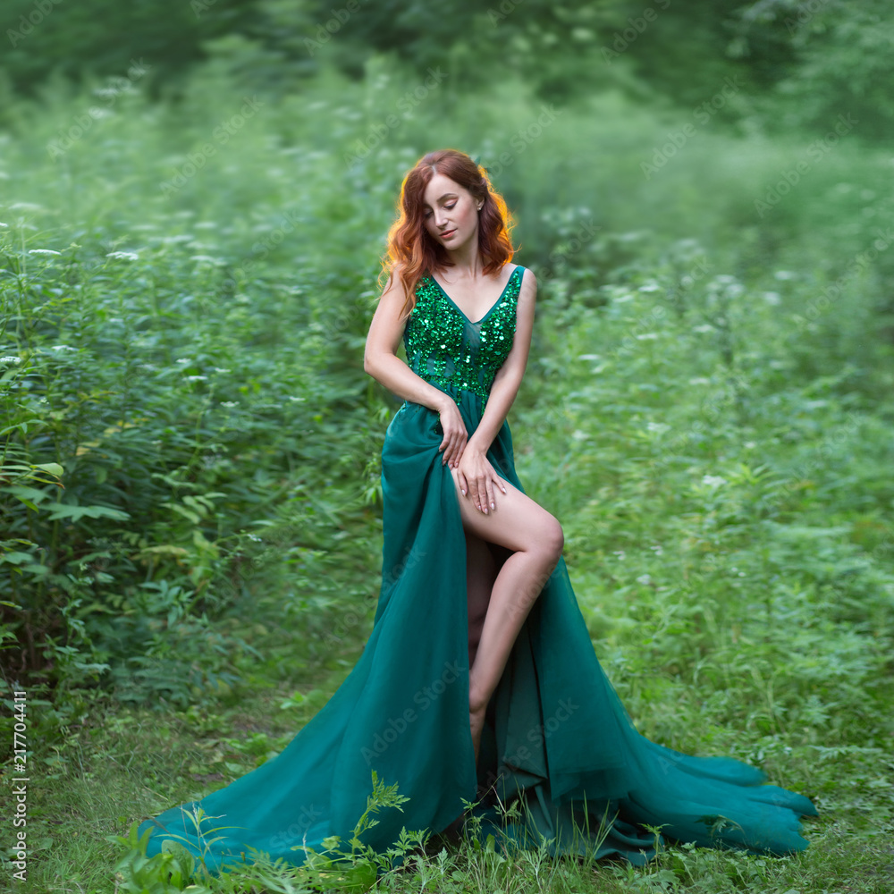 a red hair witch in green dress with long train Stock Photo
