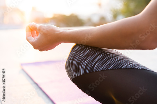 Close up hands. Woman do yoga outdoor. Woman exercising vital and meditation for fitness lifestyle club at the nature background. Healthy and Yoga Concept