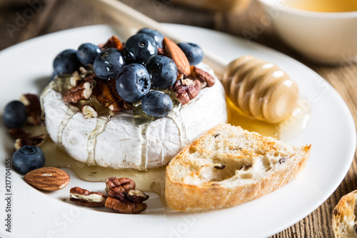 Camembert cheese with honey, nuts and fresh blueberries
