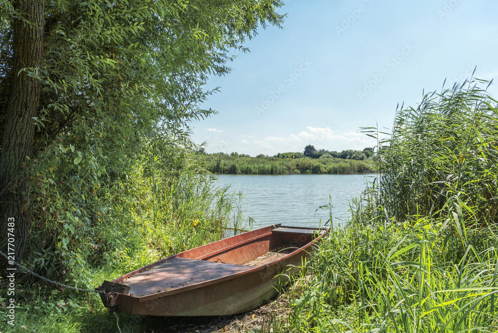 Lake landscape with metal fishing boat