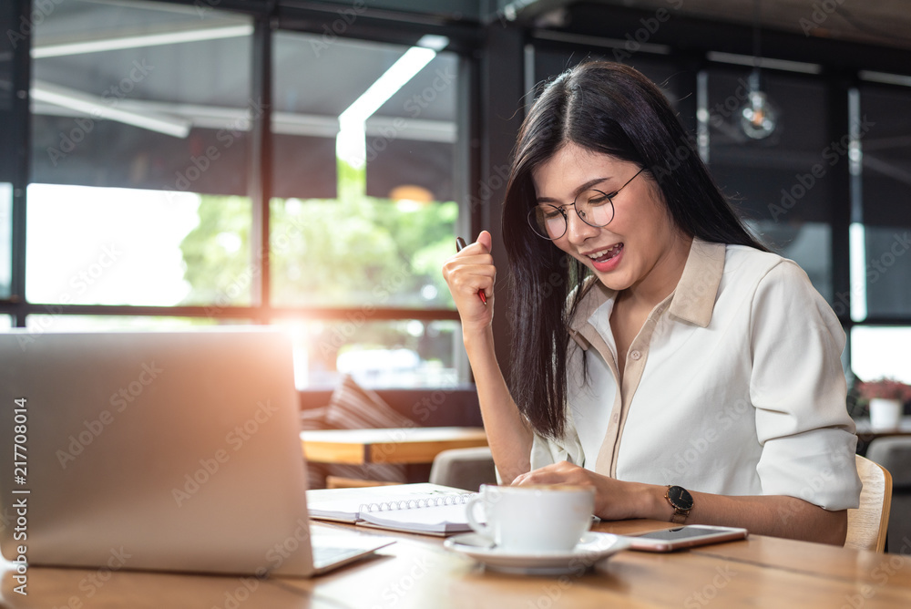 Beauty Asian woman having cheerful gesture after finishing job happily with laptop computer in cafe. People and lifestyles concept. Technology and Business working theme. Occupation and job theme. Beauty Asian woman having cheerful gesture after finishing job happily with laptop computer in cafe. People and lifestyles concept. Technology and Business working theme. Occupation and job theme.