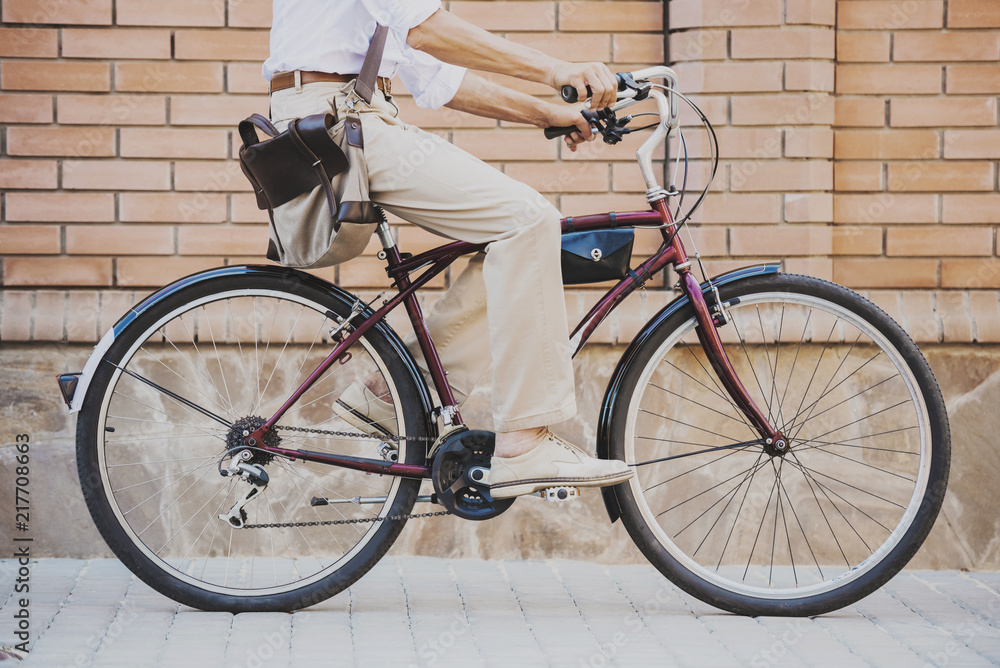 Naklejka premium Close up. Man Sitting on Bicycle Outdoor in Summer