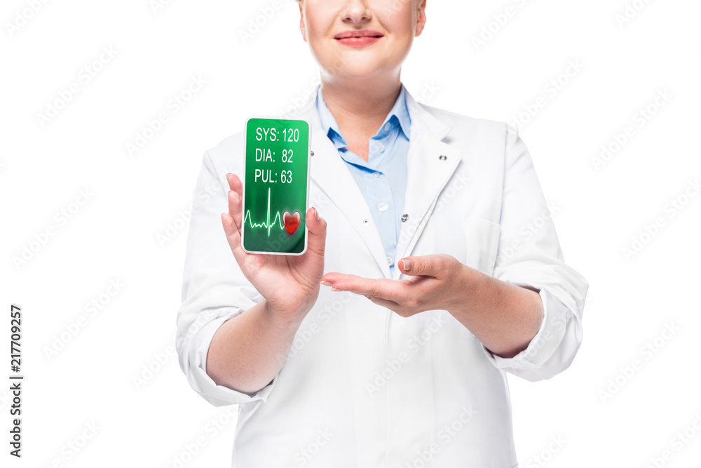 partial view of female doctor pointing at smartphone with heart rate monitor on screen isolated on white background partial view of female doctor pointing at smartphone with heart rate monitor on screen isolated on white background