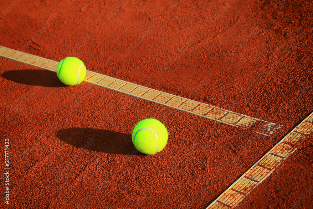 Tennis balls on a tennis clay court